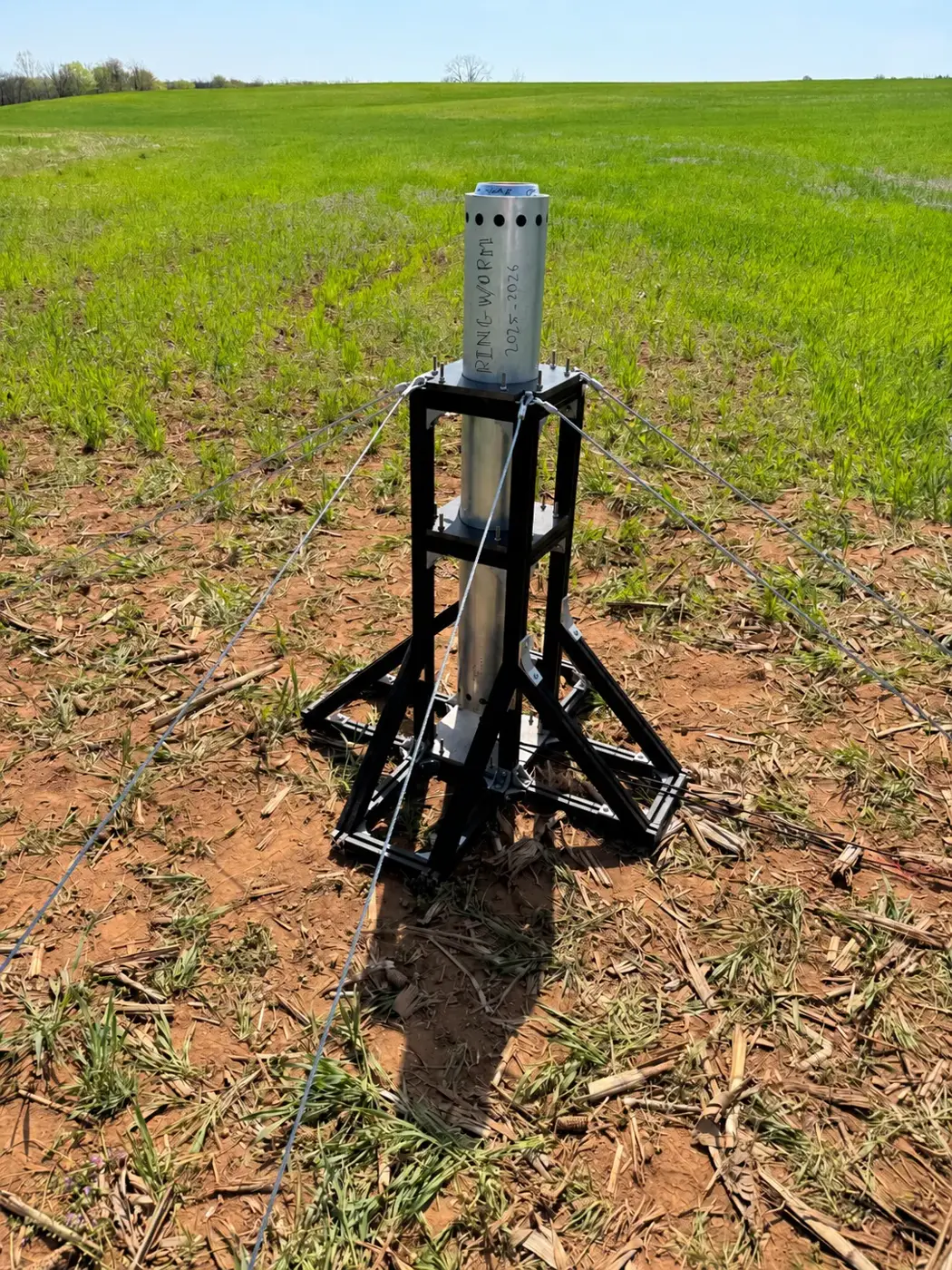 A vertical static fire test stand standing in an open field