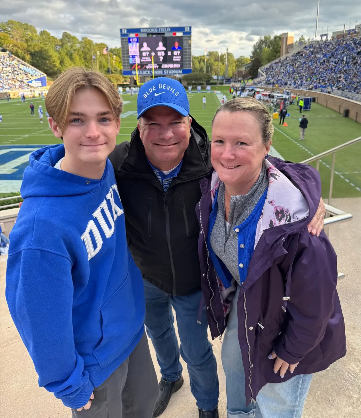 Cole with his parents at a Duke football game