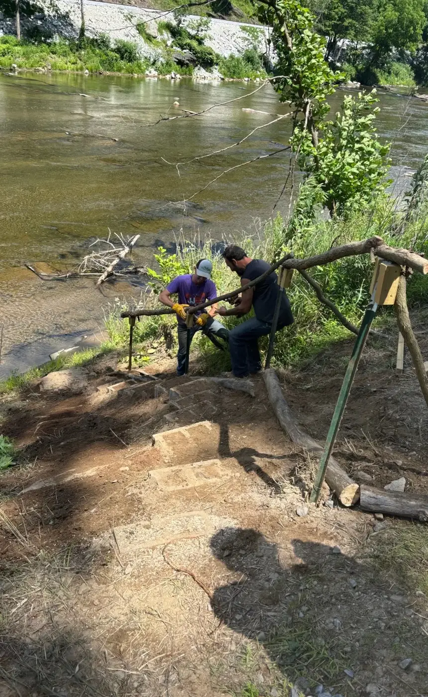 Rebuilt stairs leading down a bank to a river