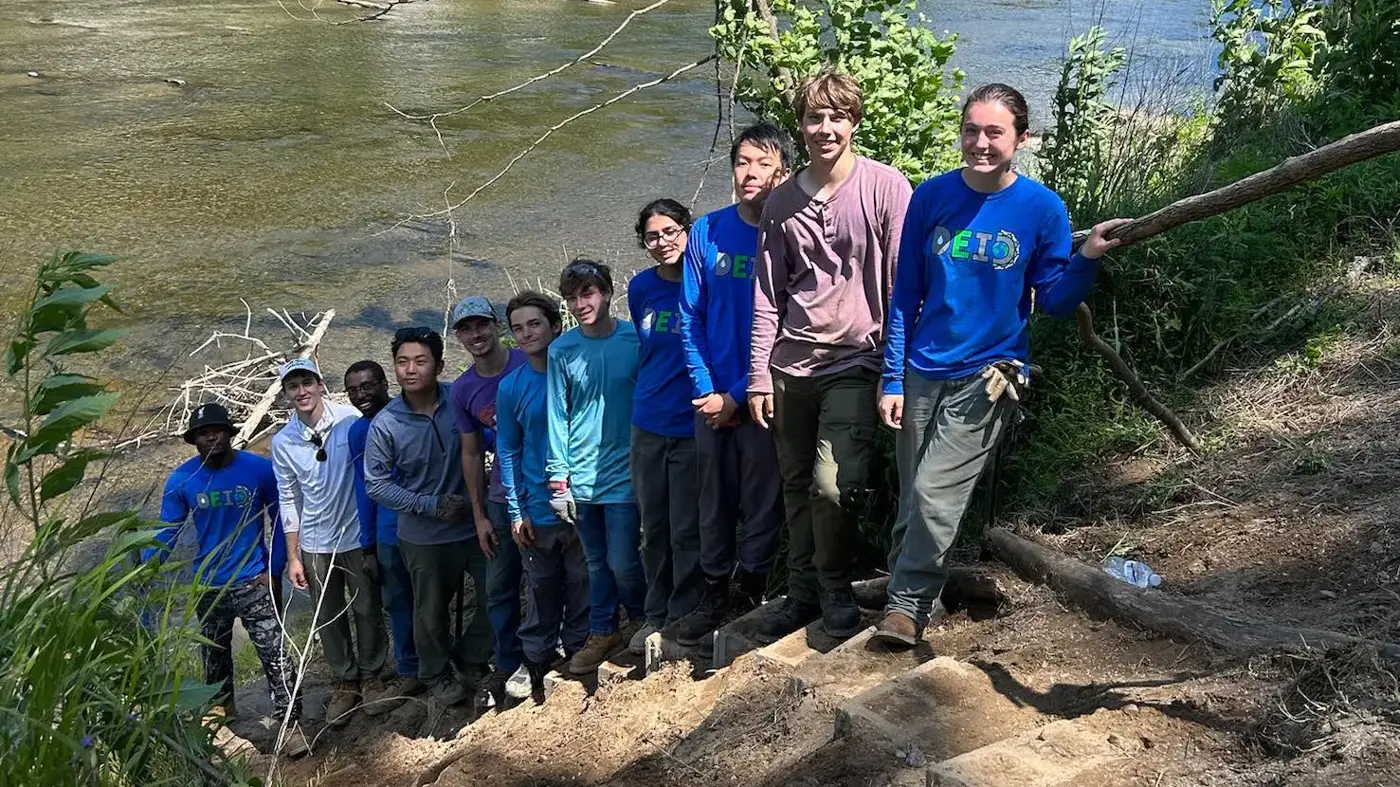 DukeEngage volunteers posing together on a hillside work site